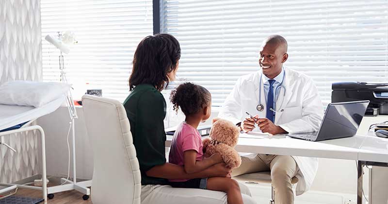 Doctor meets parent with child patient