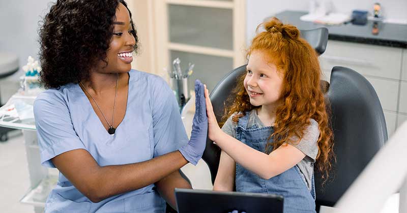 Nurse clapping with young patient