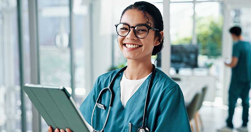 Nurse smiling with tablet